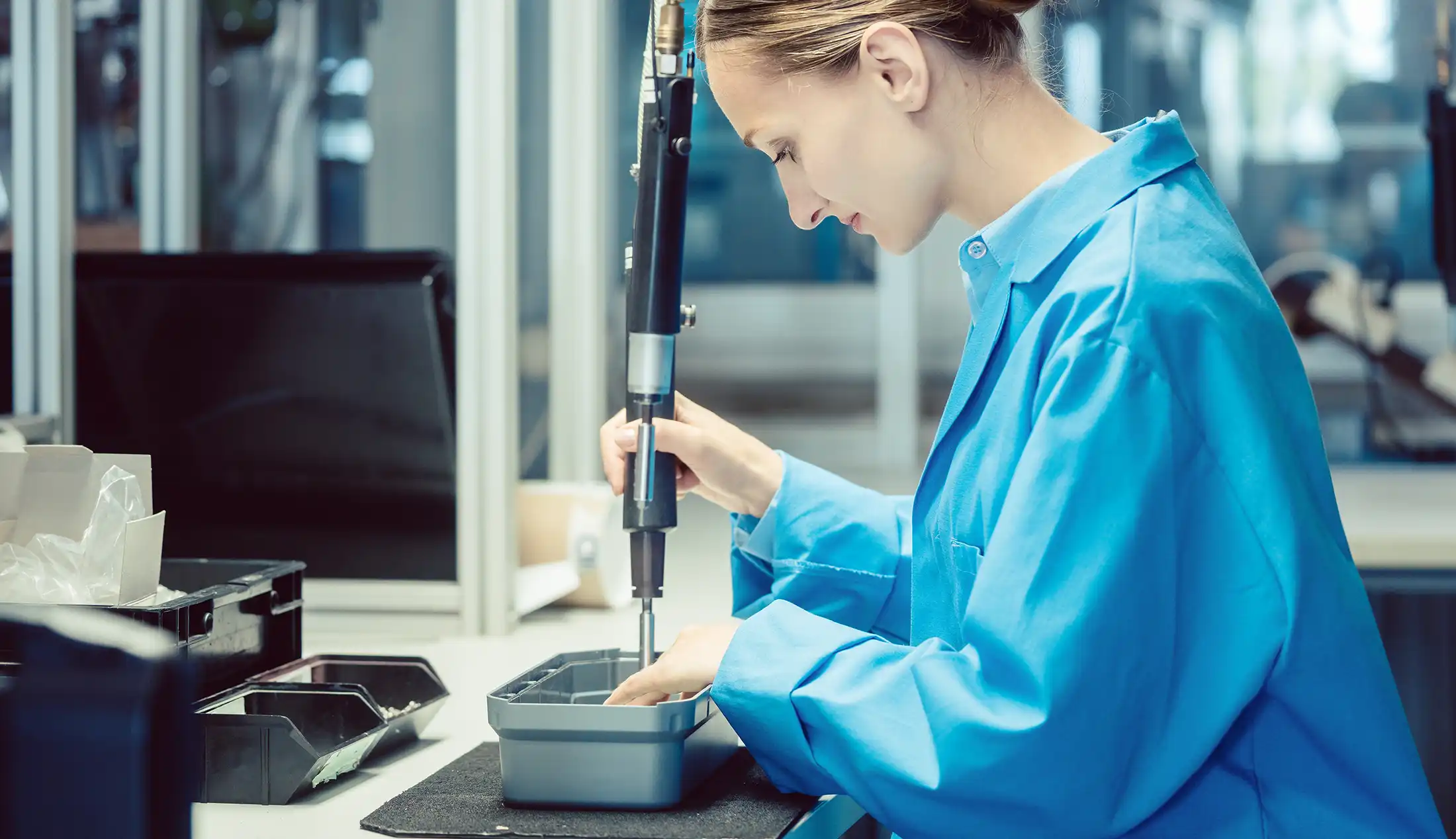 Woman in factory assembling a product