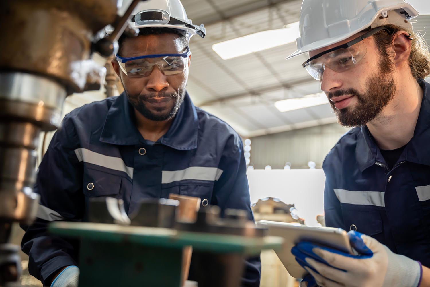 Team of engineers practicing maintenance Taking care and practicing maintenance of old machines in the factory so that they can be used continuously.